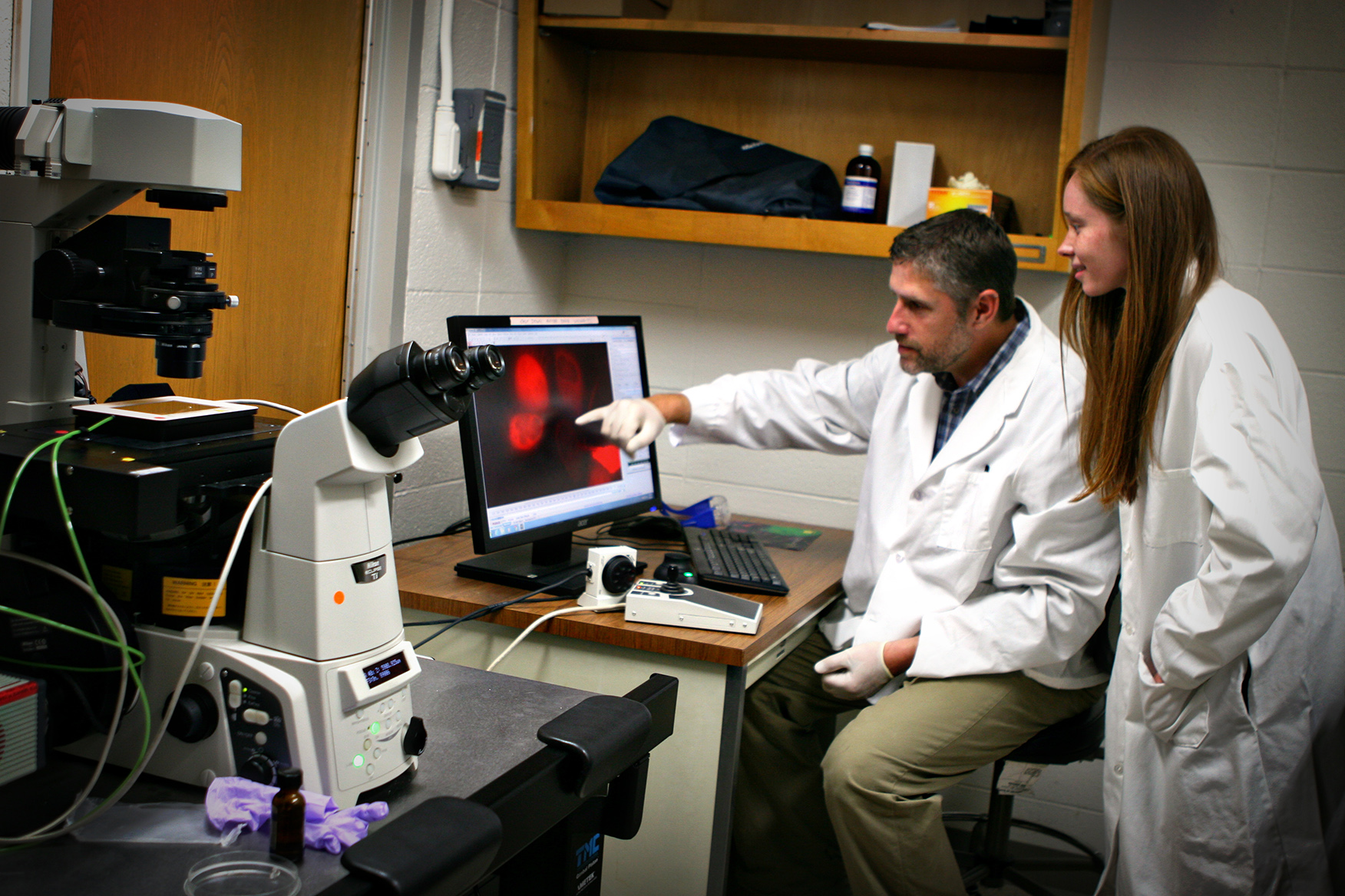 Two scientists looking at a computer screen