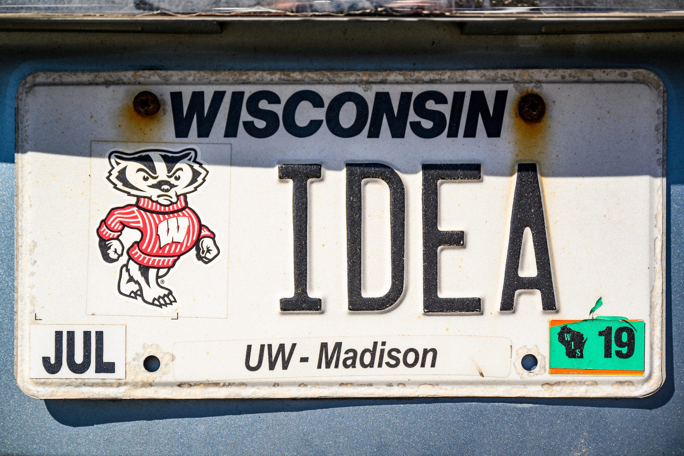 License plate that says Wisconsin Idea with Bucky badger picture