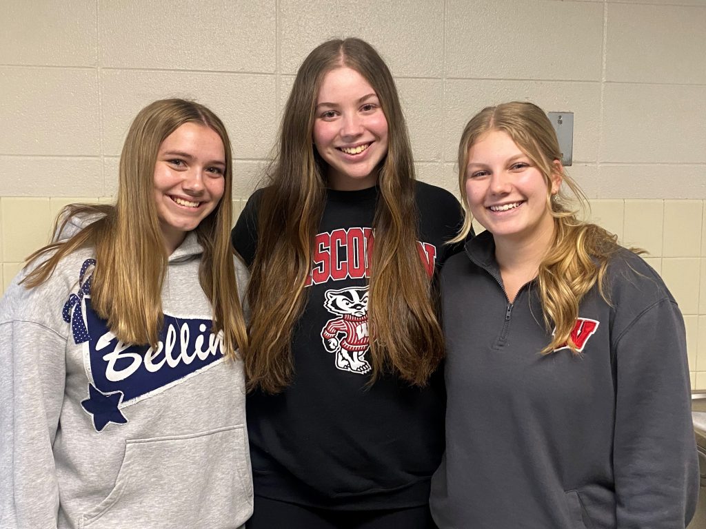 Three highschool girls wearing sweatshirts